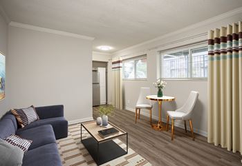 A living room with a blue couch and a coffee table.